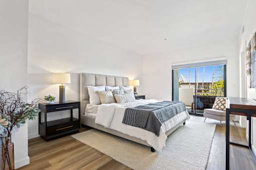 A bedroom with a large bed and a fireplace.
