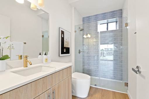A bathroom with a white toilet and a glass shower door.