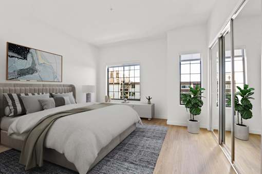 A bedroom with a large bed and a painting on the wall.