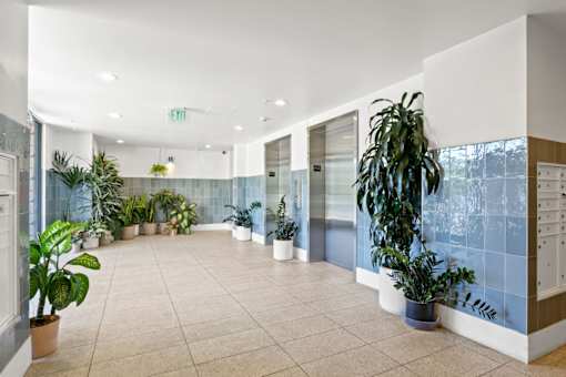 A hallway with a green exit sign above the door.