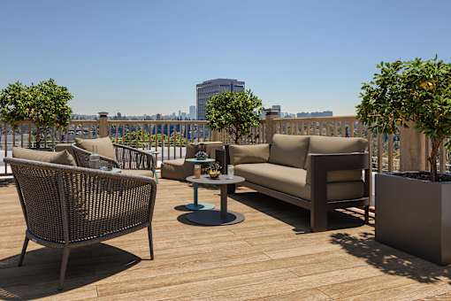 Rooftop deck with seating and sweeping Downtown skyline views