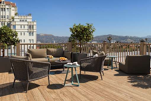 Rooftop deck with lounge seating and panoramic Hollywood hillside views