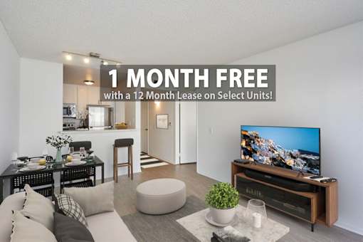 A living room with a flat screen TV on a wooden stand.