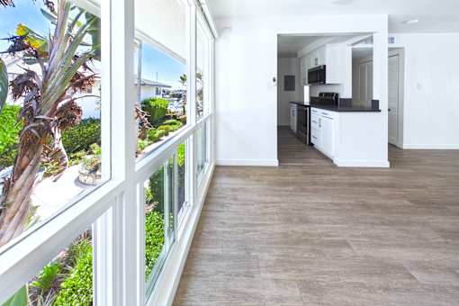 A balcony with a view of a garden and trees.