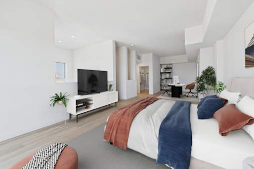 A modern bedroom with a large bed and a television.