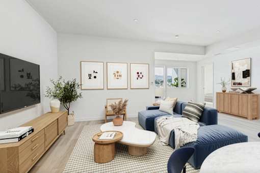 A living room with a blue couch and a coffee table.