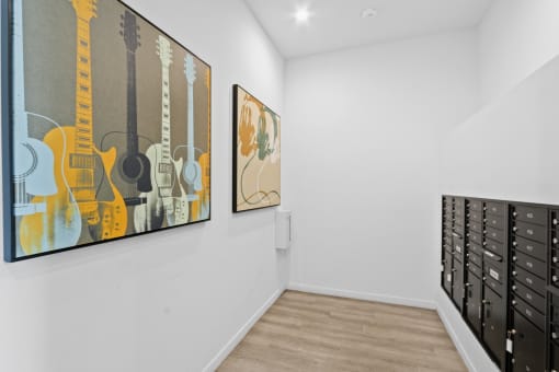 ertainment room with two paintings on the wall and a filing cabinet