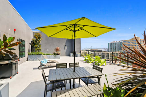 a patio with a table and chairs under an umbrella