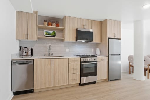 a kitchen with wooden cabinets and stainless steel appliances