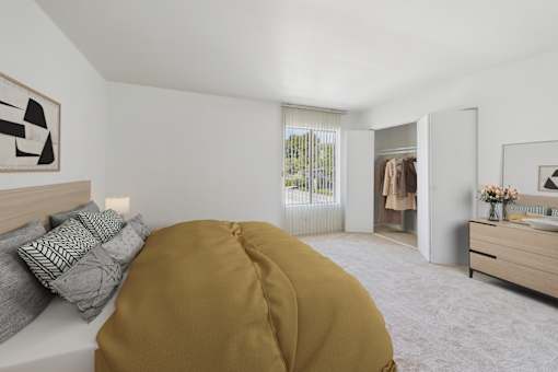 A bedroom with a bed, dresser, and mirror.
