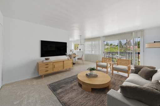A living room with a television, couch, and coffee table.