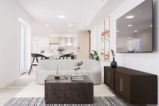 A modern living room with a white sofa and a wooden coffee table.