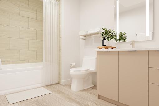 A white toilet sits in a bathroom with a white tub and a white sink.