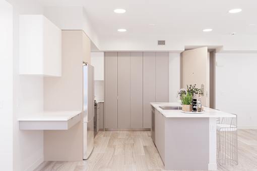 A kitchen with a white counter and a sink.