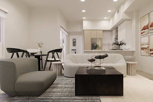 A modern living room with a grey sofa, a black coffee table, and a large window.