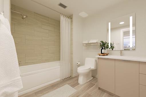 A white bathroom with a toilet, sink, and a shower.