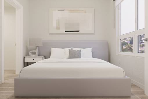A bed with white bedding and a grey headboard is in a room with a painting above it.