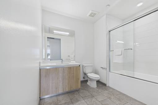 A bathroom with a toilet, sink, and shower.