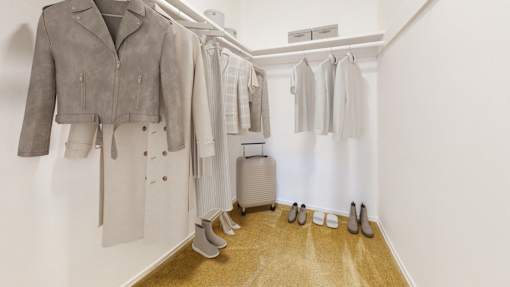 A row of shoes are lined up on a wooden floor.