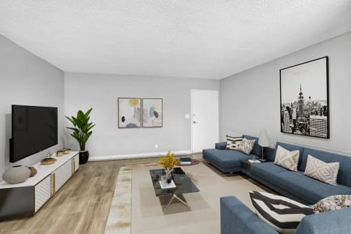 a living room with blue couches and a tv