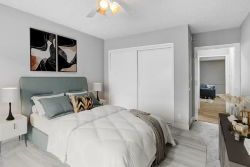 a bedroom with a large bed and a ceiling fan