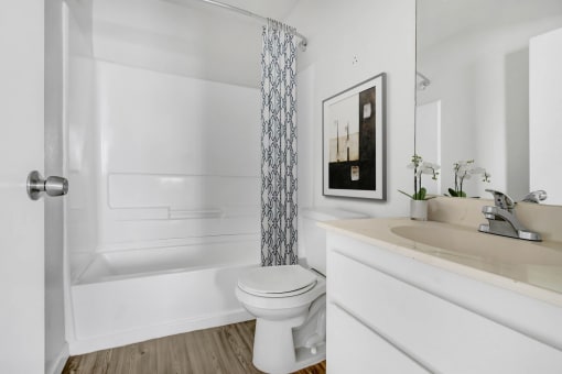 a bathroom with a toilet and a shower curtain