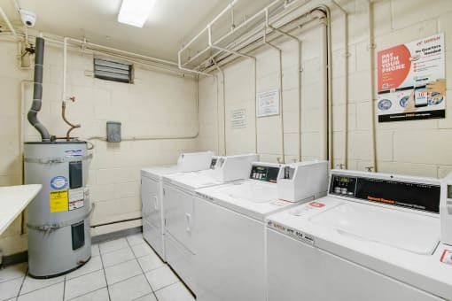 a laundry room with four washers and four washing machines