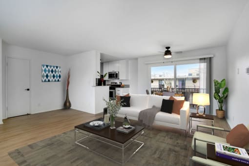 a living room with a white couch and a glass coffee table