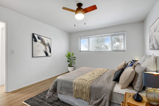 a bedroom with a large bed and a ceiling fan
