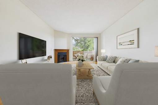 A living room with a grey couch and a coffee table.