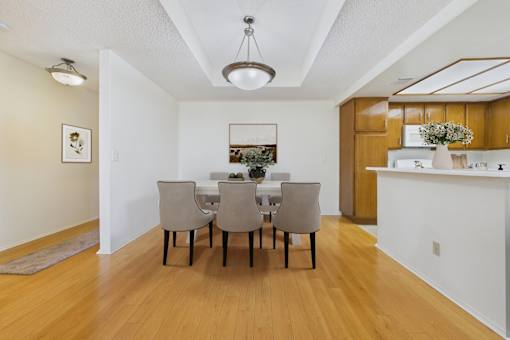A dining room with a table and chairs.