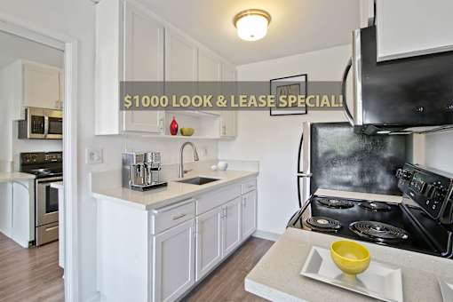 A kitchen with a stove and a counter with a yellow bowl on it.