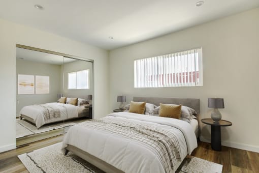 a bedroom with two beds and a large mirror
