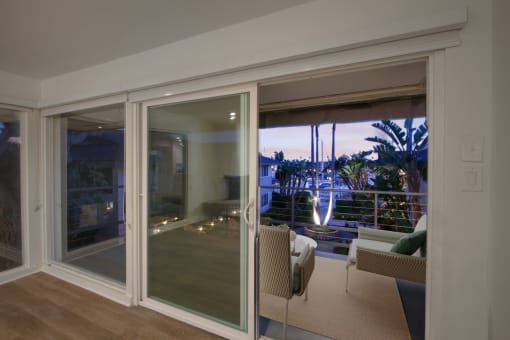 a bedroom with a large window and a balcony
