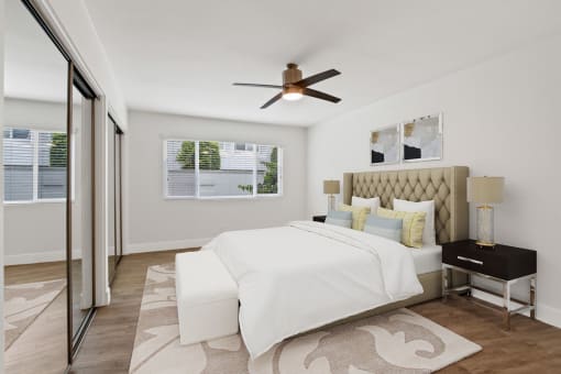 a bedroom with a bed and a ceiling fan