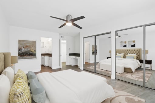 a bedroom with a large bed and a ceiling fan