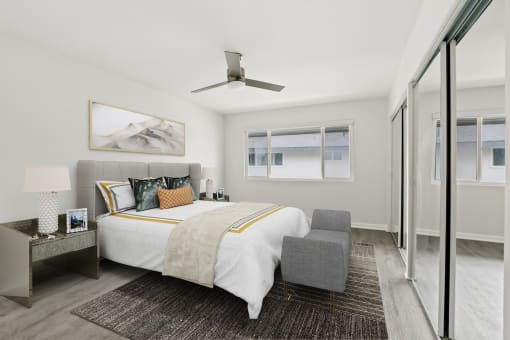 a bedroom with a large bed and a sliding glass door to a balcony