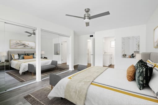 a bedroom with a bed and a ceiling fan