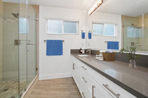 a bathroom with white walls and gray countertops