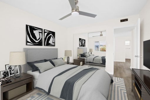 a bedroom with a bed and a ceiling fan