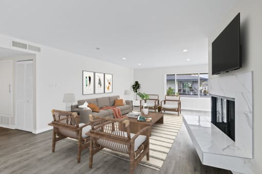 a living room with white walls and a fireplace with a tv above it