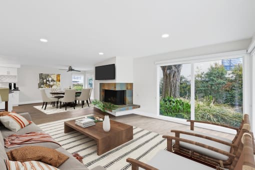 a living room with a fireplace and a large window