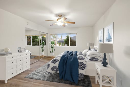a bedroom with a bed and a ceiling fan