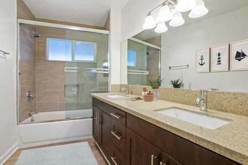 a bathroom with a large mirror and two sinks