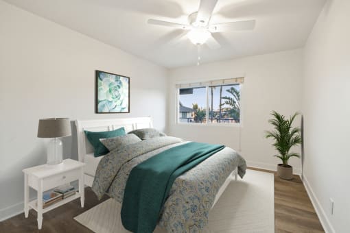 a bedroom with a bed and a ceiling fan
