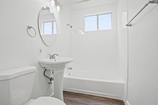 a bathroom with a sink toilet and a bath tub