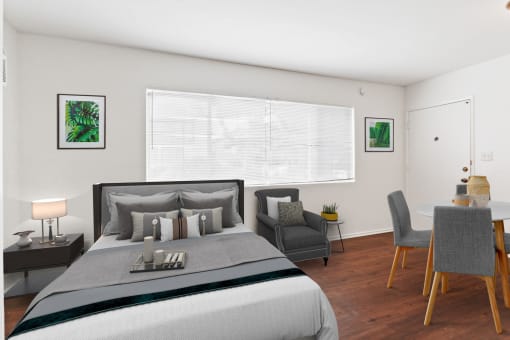 a bedroom with a bed and a chair in a room