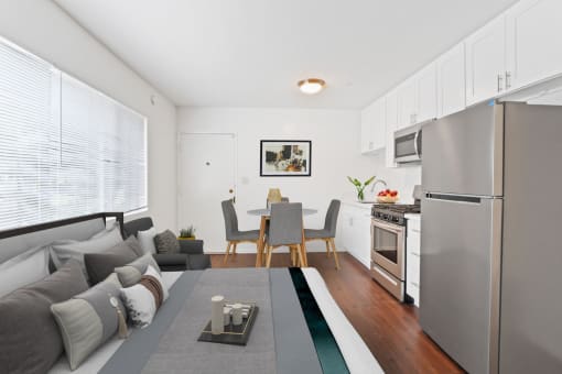 a living room with a couch a table and a refrigerator