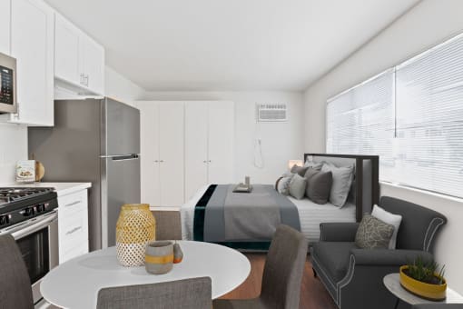 a bedroom with a bed and a table in a room