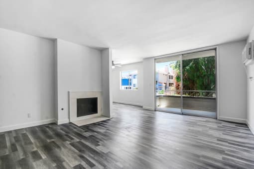 a living room with a fireplace and a balcony